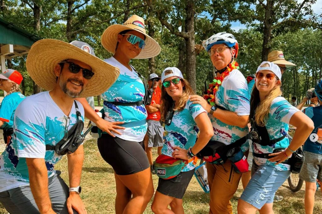 A group of athletes showing their team spirit while sporting their new custom cycling kits that all match.